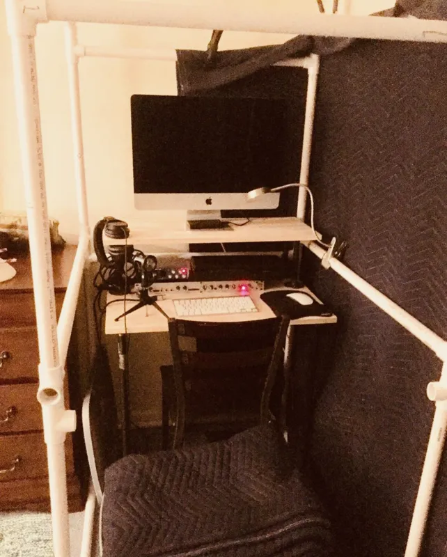 Anthony's first booth in 2017: a PVC pipe frame with packing blankets around a small desk and computer